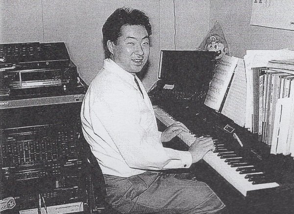 A black and white photo of a man at a piano