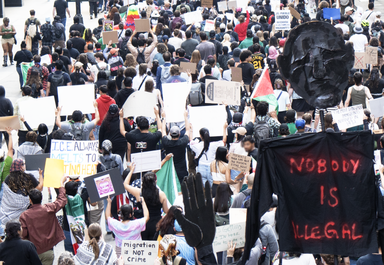 Protestors holding signs protesting ICE