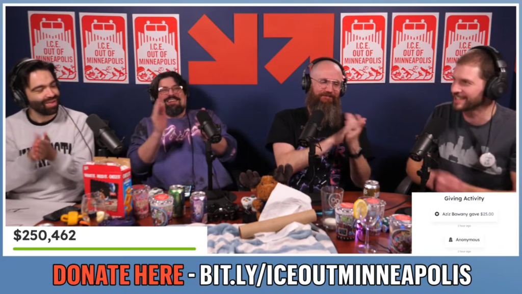 Four men sitting at a table during a livestream